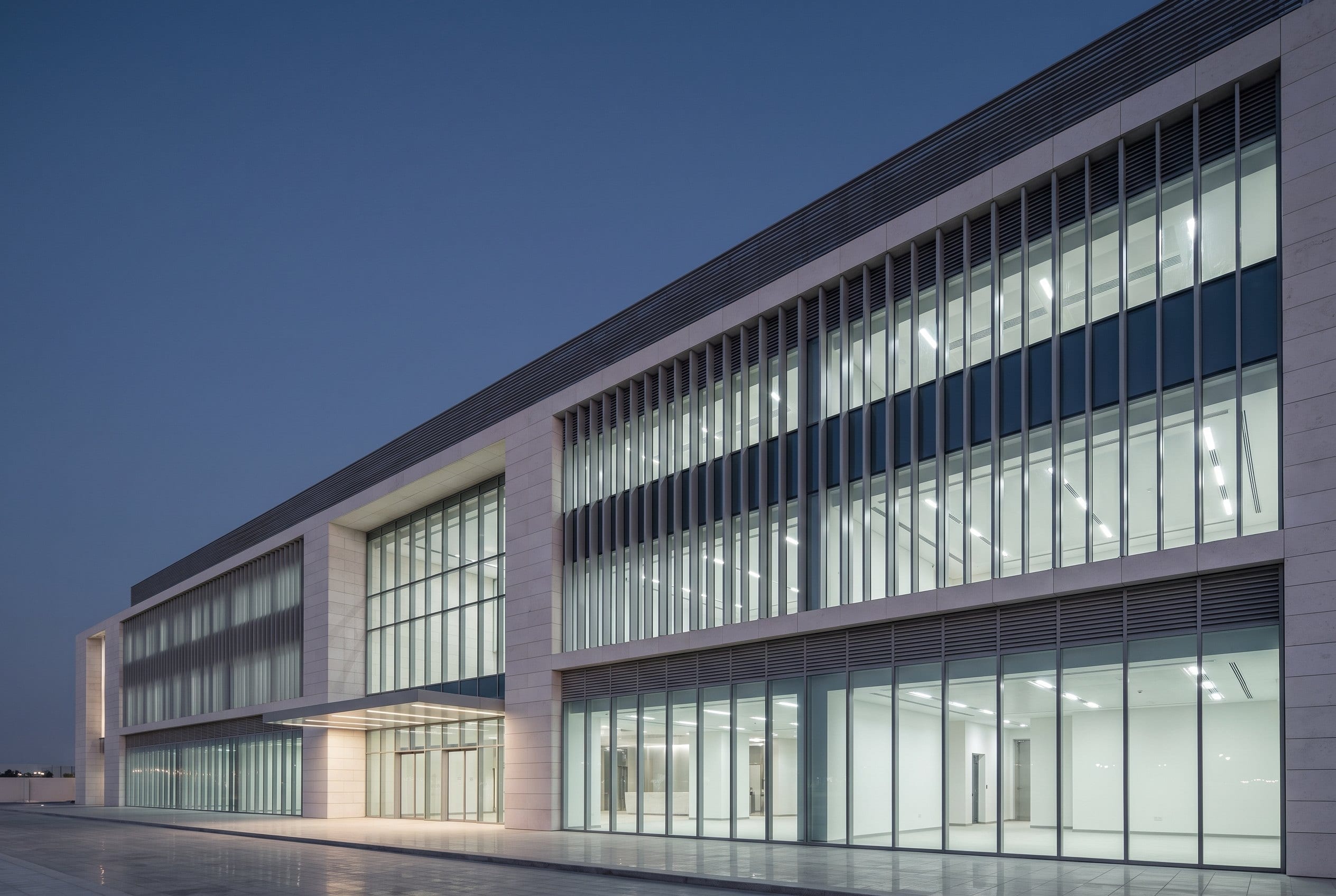The facade of a contemporary hotel building in Doha at blue hour