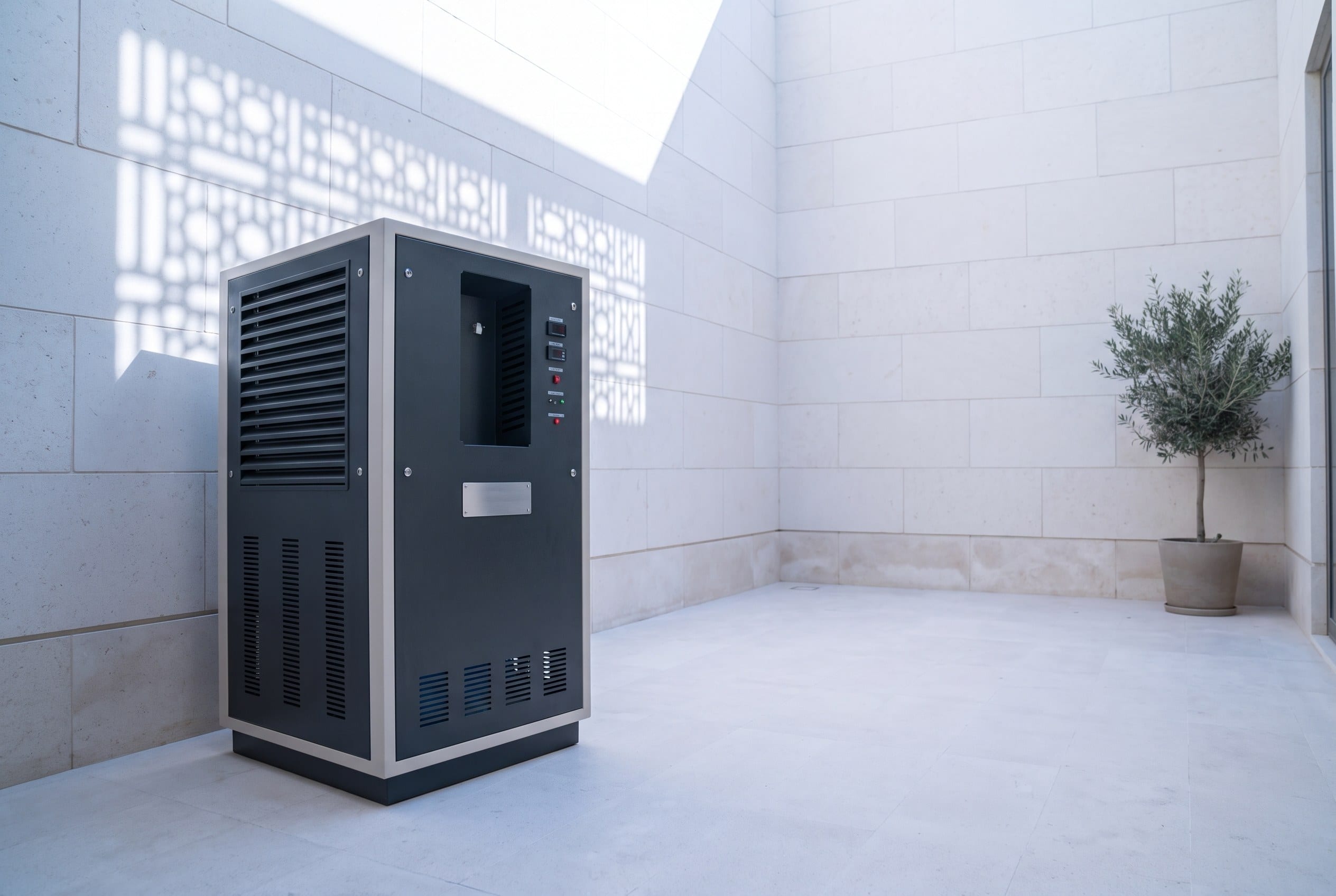A Premium series unit standing in the service courtyard of a villa, against a limestone wall under a mashrabiya shadow